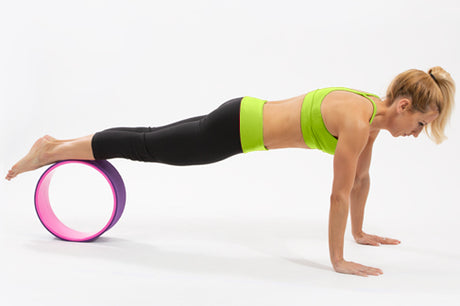 woman doing plank on prosourcefit yoga wheel