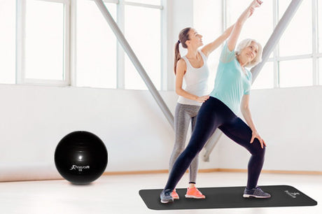 elderly woman doing yoga on prosourcefit yoga mat with prosourcefit stability ball