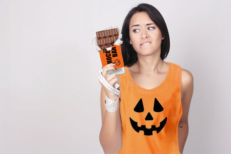 woman holding bar of chocolate during halloween