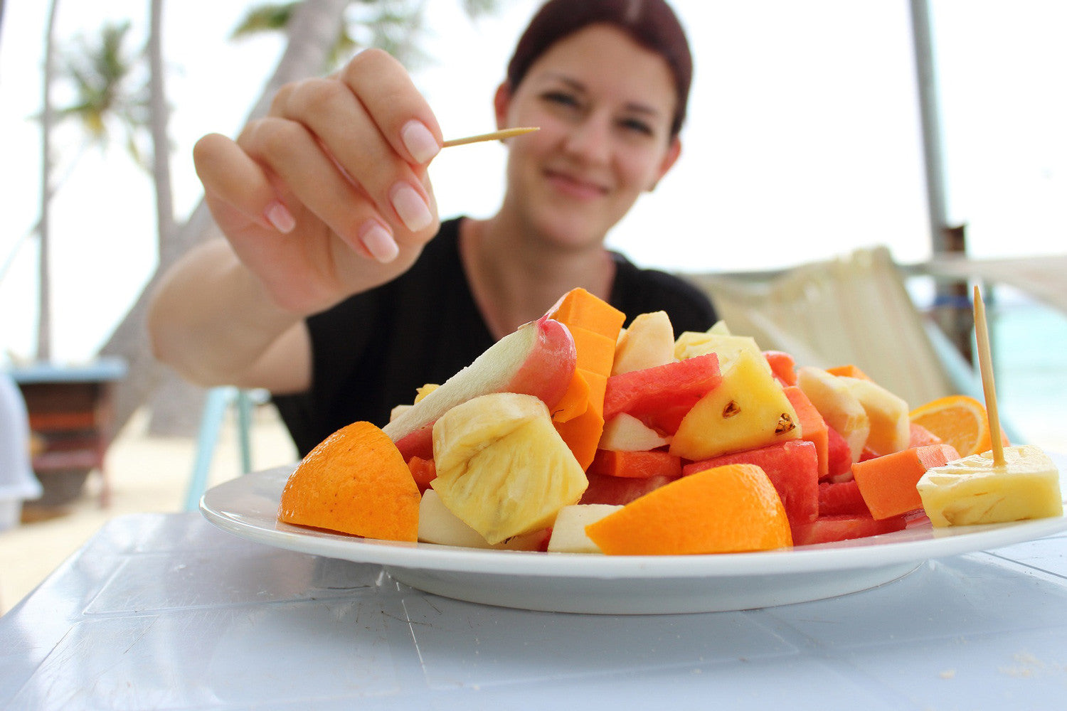 woman with fresh fruit plate